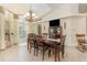 Spacious dining room features tile floors, large windows, and chandelier lighting at 1910 Palm View Dr, Apopka, FL 32712