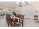 Open concept dining room with tile floors, chandelier, and sliding glass doors to the patio at 1910 Palm View Dr, Apopka, FL 32712