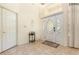 Welcoming foyer features tile flooring, high ceilings, and a decorative front door with sidelights at 1910 Palm View Dr, Apopka, FL 32712