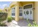 Beautiful front entry features decorative white door, sidelights, and covered porch at 1910 Palm View Dr, Apopka, FL 32712