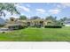 Inviting one-story home with lush front lawn, charming landscaping, and attached two car garage at 1910 Palm View Dr, Apopka, FL 32712