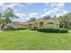 Charming one-story home with manicured lawn, mature trees, and well-maintained landscaping at 1910 Palm View Dr, Apopka, FL 32712