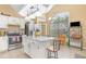 Bright kitchen featuring white cabinets, stainless steel appliances, and a granite island at 1910 Palm View Dr, Apopka, FL 32712