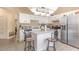 Well-lit kitchen has stainless steel appliances and white cabinets with a granite island at 1910 Palm View Dr, Apopka, FL 32712