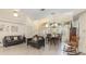 Inviting living room with tile flooring, comfortable seating, and a view into the dining area at 1910 Palm View Dr, Apopka, FL 32712