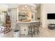 Bright living space featuring a breakfast bar, tile floors, and an entertainment center at 1910 Palm View Dr, Apopka, FL 32712