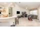 Open-concept living space features tile flooring, breakfast bar, and home office area at 1910 Palm View Dr, Apopka, FL 32712