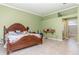 Large primary bedroom featuring a bay window, tile floors and an ensuite bathroom at 1910 Palm View Dr, Apopka, FL 32712