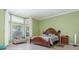Large primary bedroom featuring a bay window, tile floors and a seating area at 1910 Palm View Dr, Apopka, FL 32712