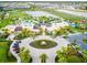 Expansive aerial view showcases the clubhouse and resort-style pool, surrounded by lush landscaping and community amenities at 1999 Tropical Palms Cir, Kissimmee, FL 34747
