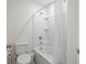 Bright bathroom features a white shower and tub combination and a standard toilet at 1999 Tropical Palms Cir, Kissimmee, FL 34747