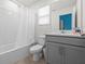 Clean bathroom features a tub with shower, a single sink vanity, and tile floors at 1999 Tropical Palms Cir, Kissimmee, FL 34747
