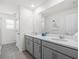Bright bathroom with double sinks, modern vanity, and tile flooring at 1999 Tropical Palms Cir, Kissimmee, FL 34747