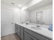 Elegant bathroom boasts double sinks, quartz countertops, and modern fixtures at 1999 Tropical Palms Cir, Kissimmee, FL 34747