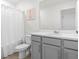 Bright bathroom with light gray vanity and combination shower and tub at 1999 Tropical Palms Cir, Kissimmee, FL 34747