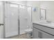 Bright bathroom with glass shower and light gray vanity at 1999 Tropical Palms Cir, Kissimmee, FL 34747