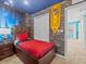 The themed bedroom includes a queen bed, brick design wall, and unique light fixture at 1999 Tropical Palms Cir, Kissimmee, FL 34747