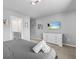 Comfortable bedroom featuring a dresser, TV, and view of an ensuite bathroom at 1999 Tropical Palms Cir, Kissimmee, FL 34747