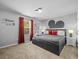 Relaxing bedroom featuring red curtains, a large bed, and Mickey Mouse themed decor at 1999 Tropical Palms Cir, Kissimmee, FL 34747