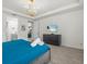 Comfortable bedroom featuring a TV, dresser, and view of an ensuite bathroom at 1999 Tropical Palms Cir, Kissimmee, FL 34747
