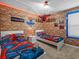 This themed bedroom features brick design wall paneling, and two twin beds with themed decor at 1999 Tropical Palms Cir, Kissimmee, FL 34747