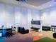 Amenity space including TV, seating area, and walls of plantation shutters at 1999 Tropical Palms Cir, Kissimmee, FL 34747