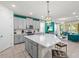 Bright kitchen with gray cabinetry, stainless steel appliances, and a spacious island open to the living area at 1999 Tropical Palms Cir, Kissimmee, FL 34747