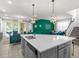 Open kitchen with sleek gray cabinets, a quartz island, and views of the stylishly decorated living and dining spaces at 1999 Tropical Palms Cir, Kissimmee, FL 34747
