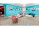 Stylish living room featuring turquoise walls, elegant furnishings, and chic decor at 1999 Tropical Palms Cir, Kissimmee, FL 34747