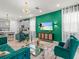 Inviting living room with a green accent wall, stylish decor, and an open view into the well-equipped kitchen at 1999 Tropical Palms Cir, Kissimmee, FL 34747