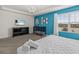 Main bedroom with a crib, large window, and television at 1999 Tropical Palms Cir, Kissimmee, FL 34747
