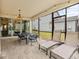 Covered patio with dining table, chandelier and lounge chairs at 1999 Tropical Palms Cir, Kissimmee, FL 34747