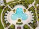 Aerial view of the cloverleaf pool features inviting lounge areas and lush landscaping, perfect for relaxing and enjoying the outdoors at 1999 Tropical Palms Cir, Kissimmee, FL 34747