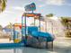 Vibrant splash pad features a water bucket and slide, creating a fun and playful environment for to enjoy at 1999 Tropical Palms Cir, Kissimmee, FL 34747