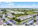 Aerial view of neighborhood and nearby pond on a bright and sunny day at 228 Primrose Dr, Davenport, FL 33837