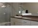 Bright bathroom featuring a shower, white cabinets and vanity at 228 Primrose Dr, Davenport, FL 33837
