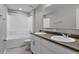 Bathroom with double sinks, white cabinets, and shower and tub combination at 228 Primrose Dr, Davenport, FL 33837