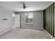 Spacious bedroom with neutral carpet, ample natural light, and a ceiling fan at 228 Primrose Dr, Davenport, FL 33837
