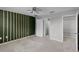 Bedroom with decorative wall, neutral carpet, ensuite bathroom, and walk-in closet at 228 Primrose Dr, Davenport, FL 33837