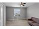 Neutral bedroom with plush carpet, gray walls, and bright window views at 228 Primrose Dr, Davenport, FL 33837