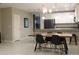 Well-lit dining room with modern furnishings adjoins kitchen, perfect for Gathering meals at 228 Primrose Dr, Davenport, FL 33837