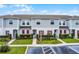 Charming townhome exterior with landscaped front yard and red shutters at 228 Primrose Dr, Davenport, FL 33837
