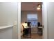 Hallway leading to a room featuring a window and desks at 228 Primrose Dr, Davenport, FL 33837
