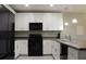 Modern kitchen with white cabinetry, black appliances, and ample counter space at 228 Primrose Dr, Davenport, FL 33837