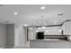 Open concept kitchen and living space with modern lighting and neutral colors at 228 Primrose Dr, Davenport, FL 33837