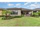 A charming backyard features lush greenery, a covered patio, and comfortable outdoor seating at 2342 Clemblue Rd, Clermont, FL 34715
