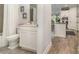 This bathroom has a shower/tub combination and a half-wall separating it from the kitchen and breakfast nook at 2342 Clemblue Rd, Clermont, FL 34715