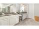 Bright bathroom with granite countertops, double sinks, and ample cabinet space for storage at 2342 Clemblue Rd, Clermont, FL 34715