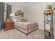 Cozy bedroom with neutral decor, a comfortable bed, stylish pillows, and a rustic bookshelf at 2342 Clemblue Rd, Clermont, FL 34715