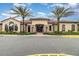 Community clubhouse featuring a stucco exterior, stone accents, and lush landscaping at 2342 Clemblue Rd, Clermont, FL 34715
